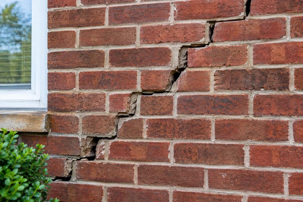 Cracked brick wall requiring masonry repair