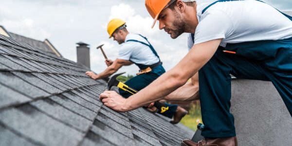 repairing roof with coworker