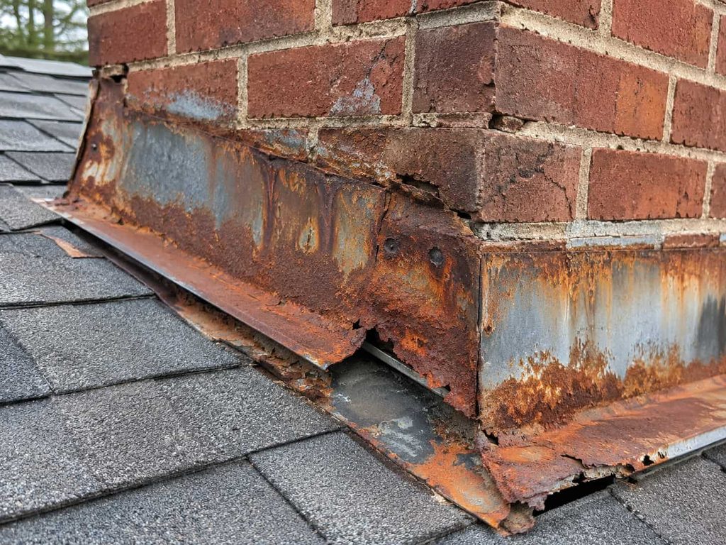 Rusted metal flashing around a chimney