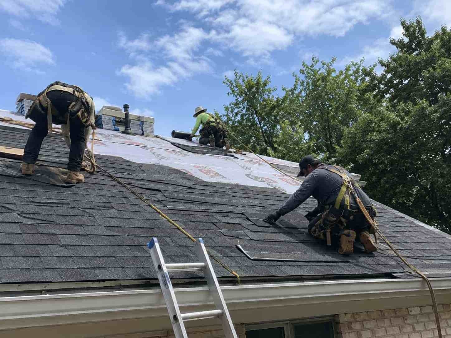 workers repairing roof damage in bethseda