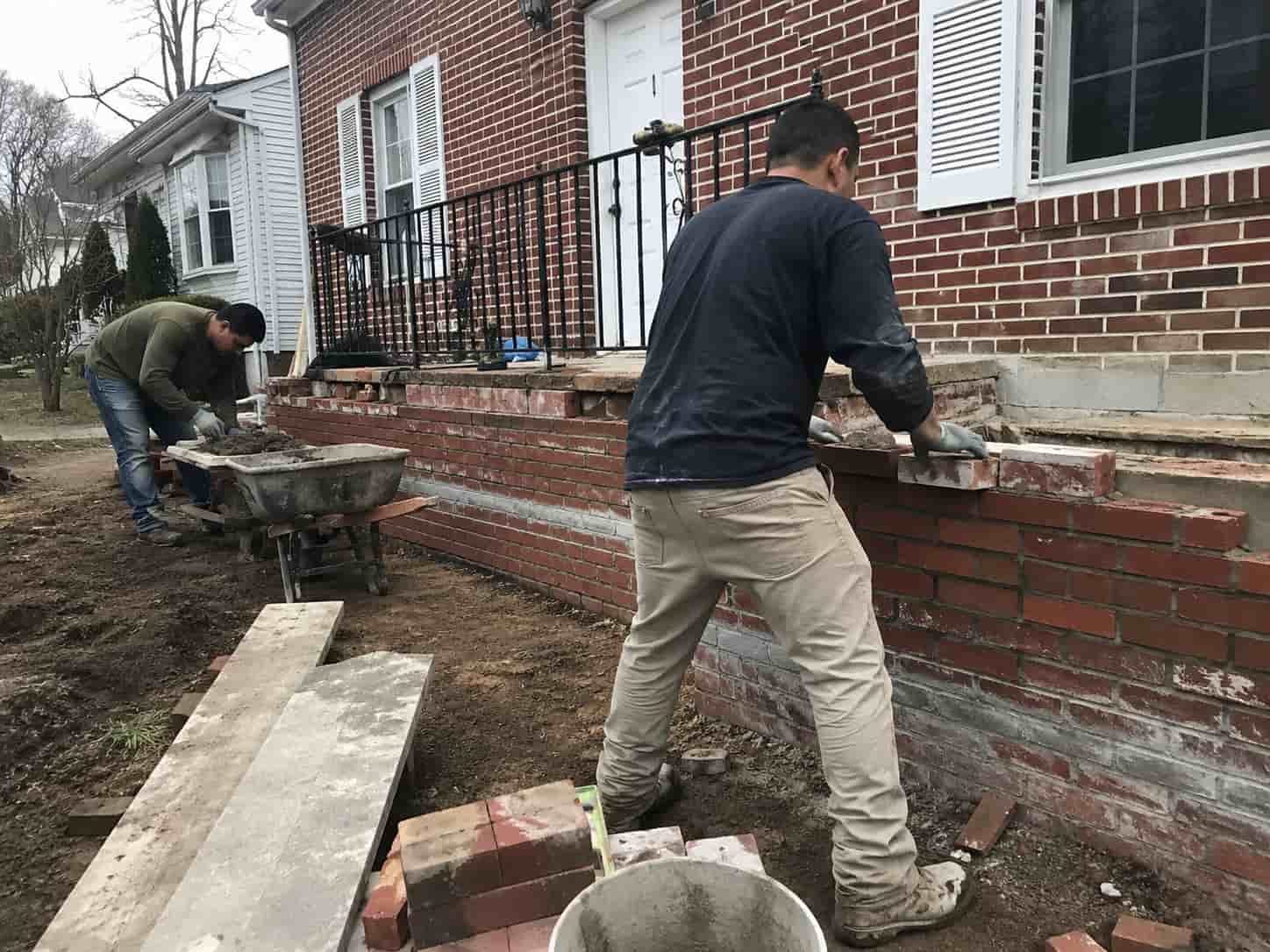 Workers Working on a Masonry Wall